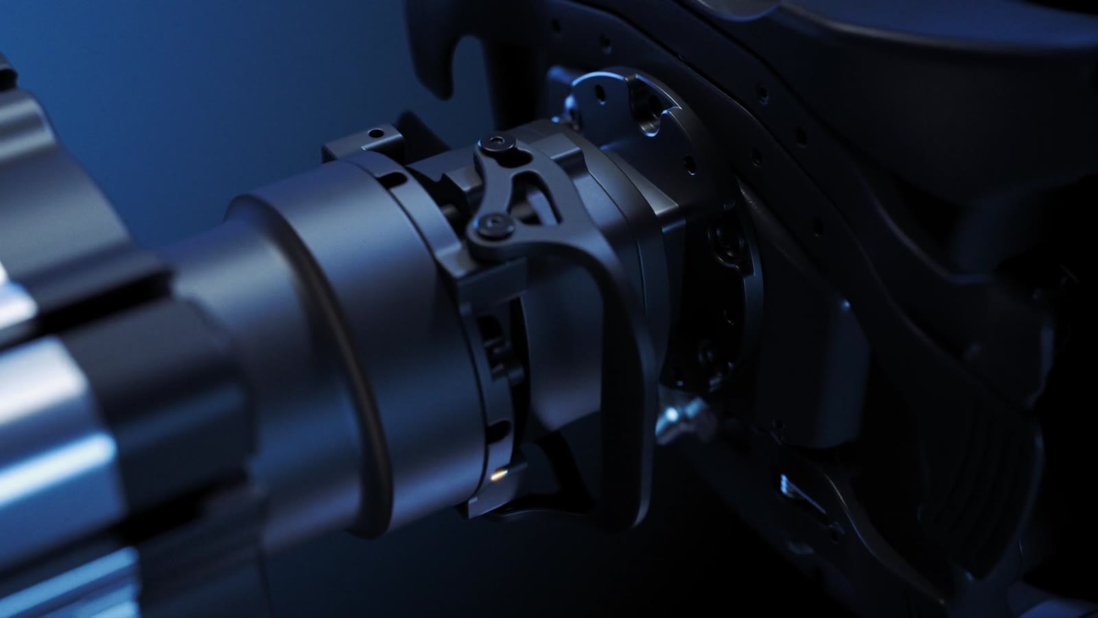 A shaft clamp and its bolt circle, machined faces catching a single edge light.